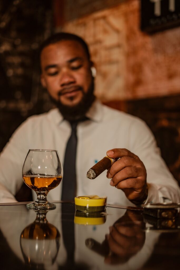 Man having a dominican cigar at a bar.
